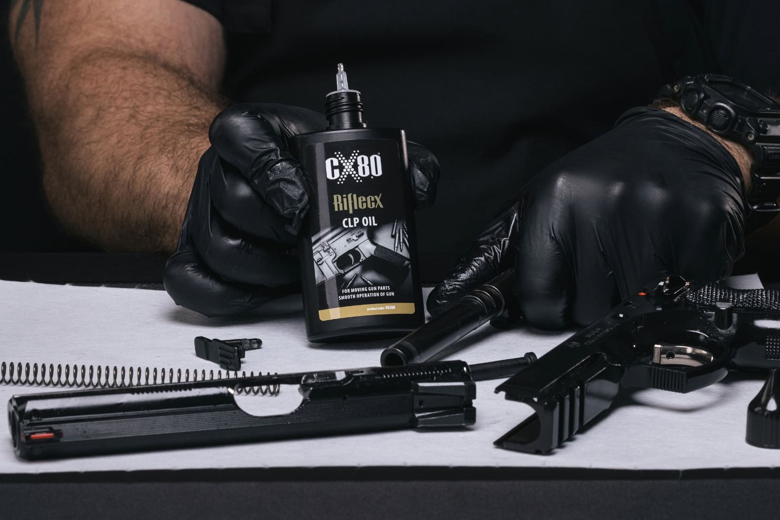 Applying RifleCX CLP Oil to firearm moving parts