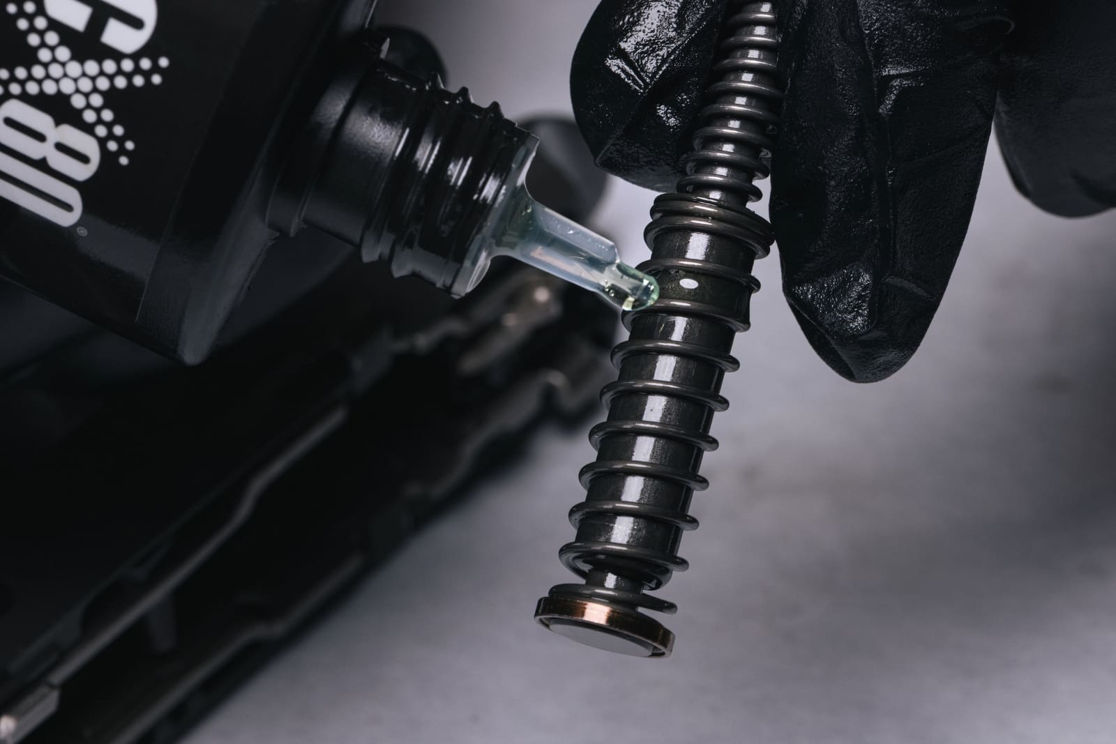 Lubricating firearm mechanisms with RifleCX CLP Oil